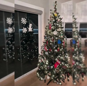 Christmas scene on the window made with Holiday Spray next to Christmas tree