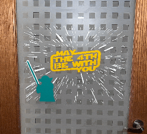 Glow-in-the-dark May the 4th be with you Star Wars Gif with Yoda holding a lightsaber.